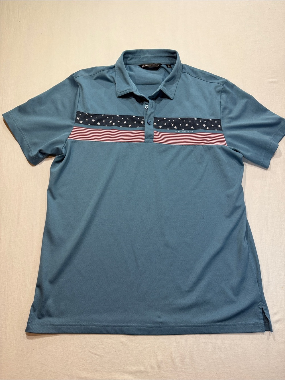 Travis Mathew Teal Polo with Navy Star & Red-White Stripe Chest Band